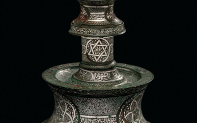 A SILVER-INLAID BRONZE CANDLESTICK, WEST IRAN OR FARS, MID-14TH CENTURY