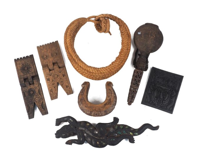 A Sumatran wood lizard, inset with glass fragments, 51cm long; two wood Quran stands; a modern Chinese wood printing block; a wood and leather flask; a braided rattan bridle; a carved wood collar; and a desert rose hard sand formation fossil, 15cm...