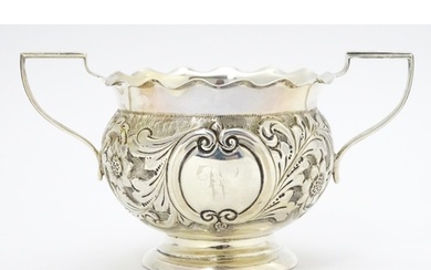 A Victorian silver twin handled bowl with embossed floral an...