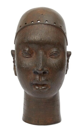A bronze female head, Yoruba, in the...