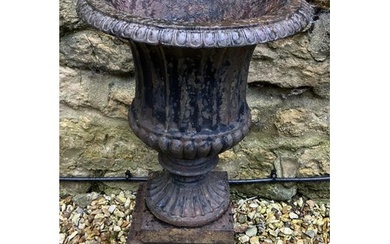 A cast iron Campana form garden urn, on a plinth base, 41 cm...