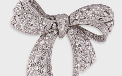 A diamond and platinum brooch designed as an articulated...