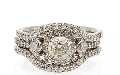 NOT SOLD. A diamond ring set with a cushion-cut diamond weighing app. 1.00 ct. encircled...