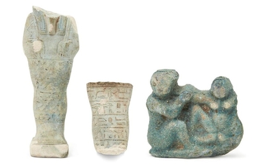 A fragmentary Egyptian blue glazed composition shabti of typical mumiform, holding two hoes, with part of the lappet wig and beard remaining, with six horizontal lines of hieroglyphic text, with a hierolyphic inscribed dorsal column, 7.8cm high and...