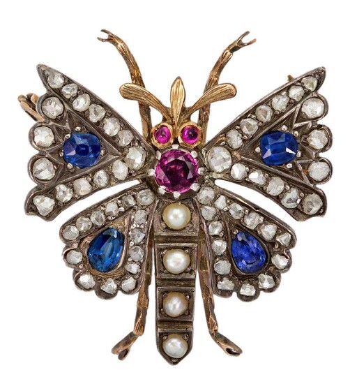 A gem-set and diamond brooch designed as a butterfly, the wings set with mixed-cut sapphires framed with rose-cut diamonds, the body set with a circular-cut ruby and half-pearls to cabochon ruby eyes, mounted in silver and gold, detachable brooch...