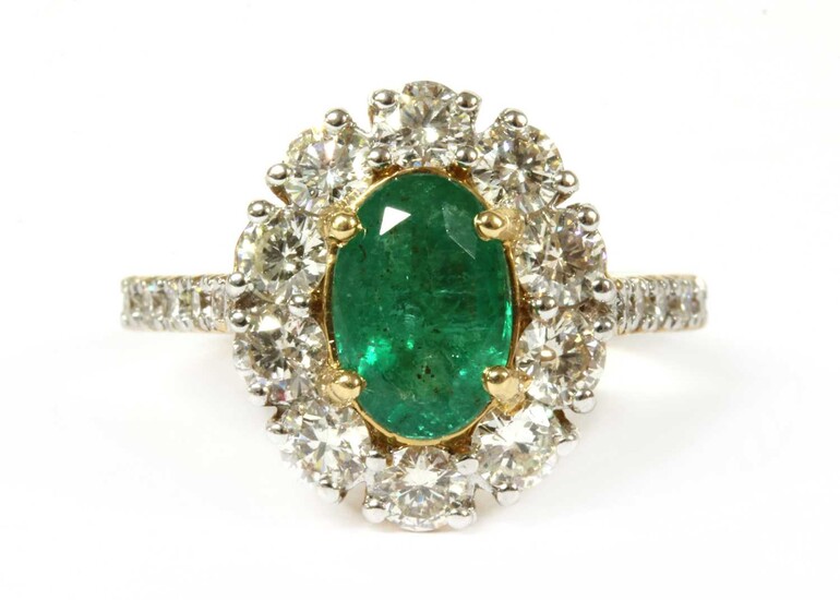 A gold emerald and diamond cluster ring