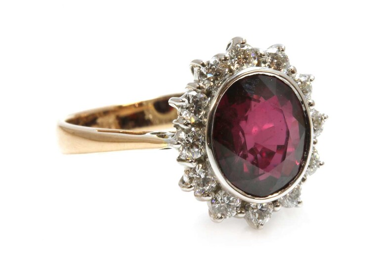 A gold ruby and diamond oval cluster ring