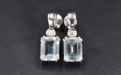 A pair of 18ct white gold stud earrings having small collared diamond drops to baguette cut Aqua
