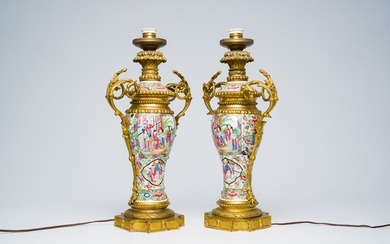 A pair of Chinese Canton famille rose vases and covers with palace scenes and floral...