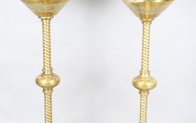 A pair of late 19th century Gothic style brass ecclesiastical pricket candle stands, each circular t