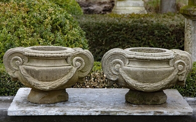 A pair of sculpted sandstone planters