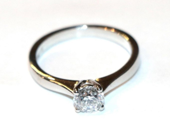 A platinum diamond solitaire ring, a round brilliant cut diamond...