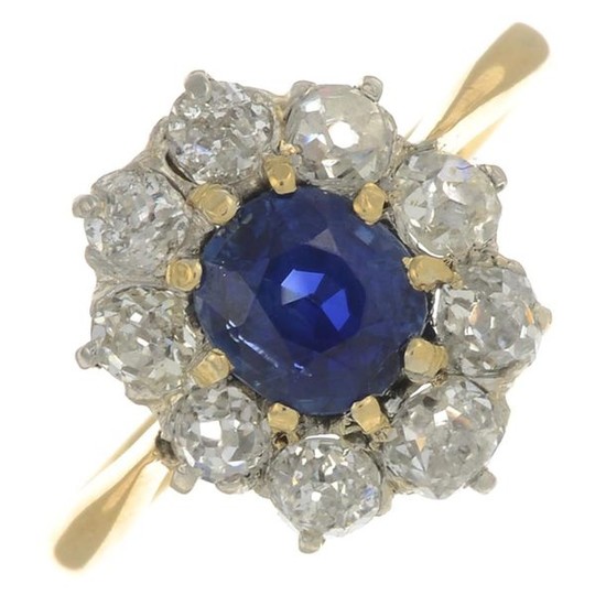 A sapphire and diamond cluster ring.With report 79231-75,...