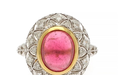 A tourmaline and diamond ring set with a cabochon pink tourmaline and numerous brilliant-cut diamonds, mounted in in 18k gold and white gold. Size 55.