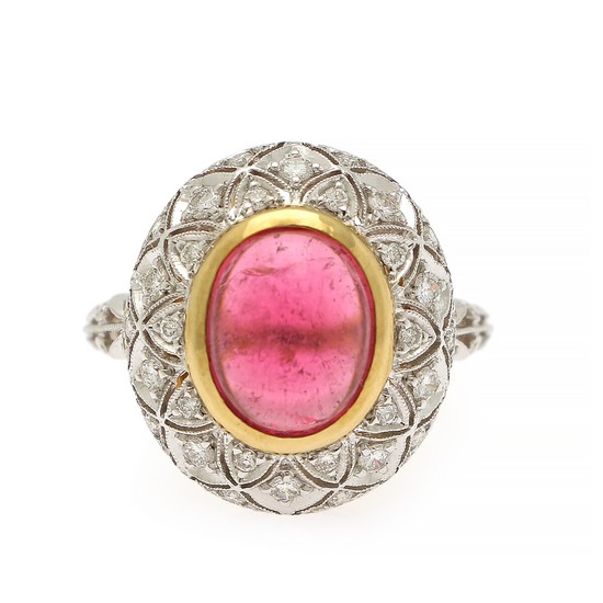 A tourmaline and diamond ring set with a cabochon pink tourmaline and numerous brilliant-cut diamonds, mounted in in 18k gold and white gold. Size 55.