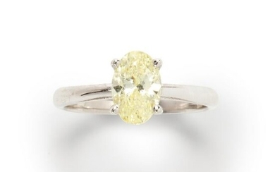 A yellow diamond and fourteen karat white gold ring