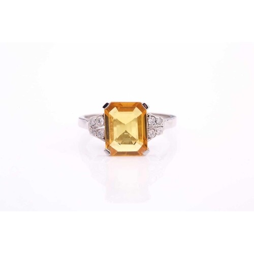 A yellow sapphire and diamond ring, the 10.5x8mm yellow sapp...