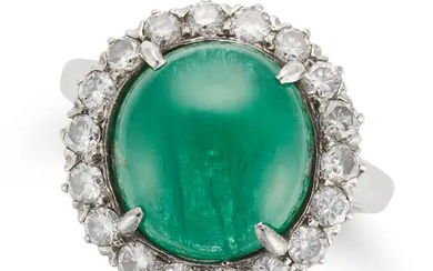 AN EMERALD AND DIAMOND CLUSTER RING set with a rou ...