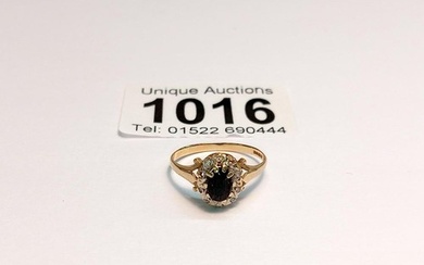 An 18ct gold diamond and sapphire ring, size K 1.8 grams.
