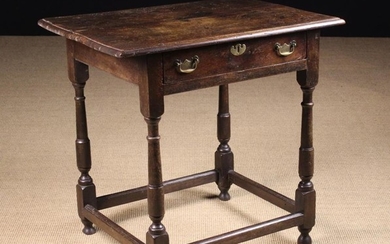 An 18th Century Oak Side Table. The top with moulded edge above a frieze drawer with brass swing han