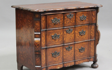 An 18th century Dutch floral marquetry serpentine fronted bombé commode, fitted with three draw