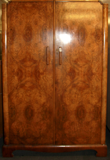 An Art Deco walnut veneered double wardrobe, W. 117cm H. 185cm.