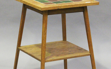 An Edwardian Arts and Crafts oak two-tier occasional table, possibly by Liberty & Co, the top in