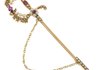 An early 20th century gold ruby and split pearl sword jabot pin.