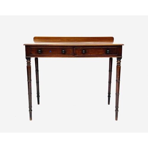 An early Victorian mahogany side table, with raised back and...