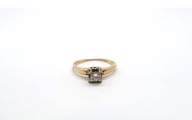 An illusion set 14ct yellow gold and diamond solitaire ring ...