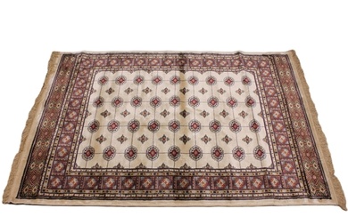 An ivory ground Kashmir traditional Bokhara rug, in red, blu...