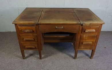 An oak typists desk, early 20th century, the rectangular top with folding and recessed typewriter