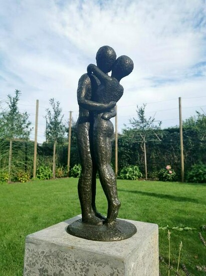 Bronze garden sculpture of an embracing couple