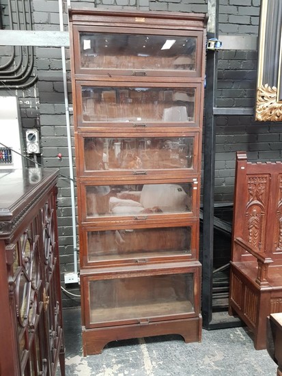 Early 20th Century Australian Oak Stacking Legal Bookcase by Butterworth, of six sections with one larger, all with glass panel door...