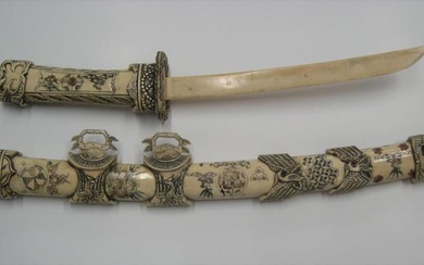 Japanesesque 20thC engraved bone decretive sword, the sword and...