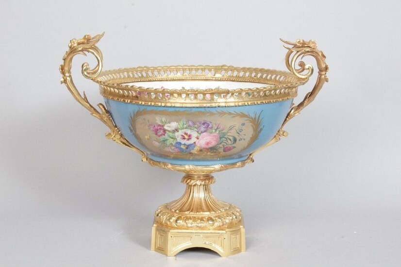 Large porcelain bowl in the taste of Sèvres, decorated on a blue background with gold leafed cartouches and polychrome flower bouquets, the white interior decorated with a garland of flowers and a bouquet. Beautiful ormolu gilt bronze frame chiselled...