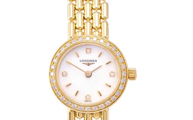Longines: A Lady's 18 Carat Gold Diamond Set Wristwatch, signed...