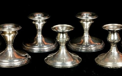(Lot of 7) Five sterling weighted candlesticks with