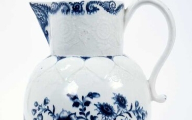 Lowestoft jug, of large size, the neck moulded with flowers and leaves, lappets and florets around the shoulder and foot, painted in blue with flowering plants, painter's number 5 inside footrim, 2...