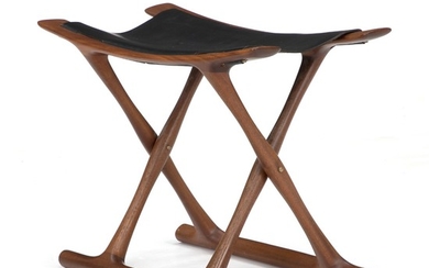 Ole Wanscher: “Egyptian Stool”. A mahogany folding stool. Seat of black leather. Manufactured and marked by P. Jeppesen.