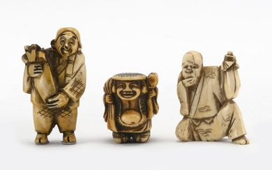 THREE JAPANESE IVORY NETSUKE One in the form of Hotei, one in the form of a kneeling man holding a mask and sack, and one in the for...