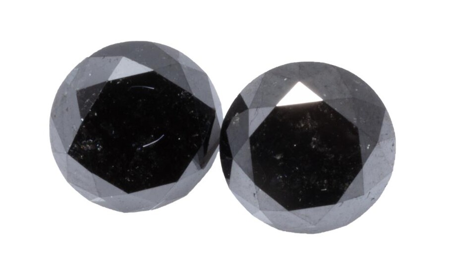 TWO UNSET ROUND BRILLIANT CUT BLACK DIAMONDS; 1.68ct (6.74 x 5.26mm) & 1.50ct (6.75 x 4.92mm) treated stones.