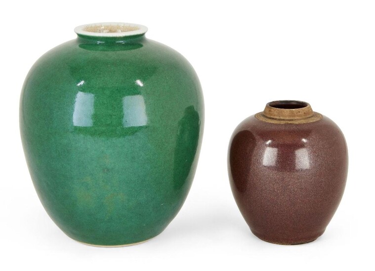 Two Chinese porcelain monochrome jars, 18th century, both of ovoid form, one covered in an apple-green glaze beneath the white rim, the other with an 'iron-rust' glaze, 11.3cm - 17.5cm high (2)