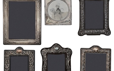 Two Edwardian silver mounted photograph frames and four modern frames