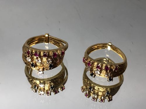 Two gold rings, one consisting of three rings...