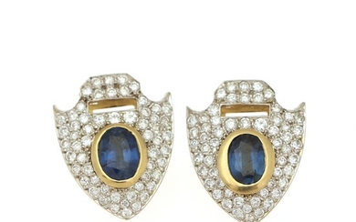A pair of sapphire and diamond ear pendants each set with an oval-cut sapphire and numerous brilliant-cut diamonds, mounted in 18k gold and white gold. (2)