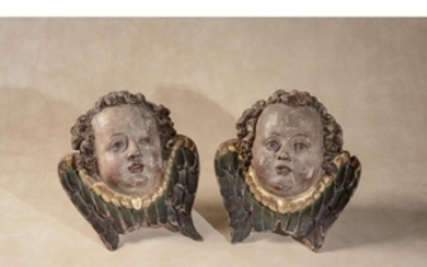 Manner of Michel Erhart, (German, circa 1440- 1520), a pair of south German or Tyrolean carved and painted wood wall mounting winged cherub heads