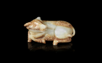 A pale green and russet jade carving of a buffalo