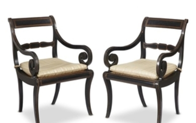 A pair of Regency ebonized and parcel-gilt armchairs first...