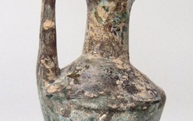 A Roman blue-green glass single-handled bottle